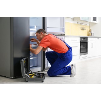 /male-technician-with-screwdriver-repairing-refrigerator-in-kitchen_217652.jpg